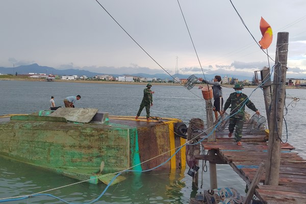 Tàu cá bị lật nghiêng khi đang neo đậu ở sông Nhật Lệ - Anh 1